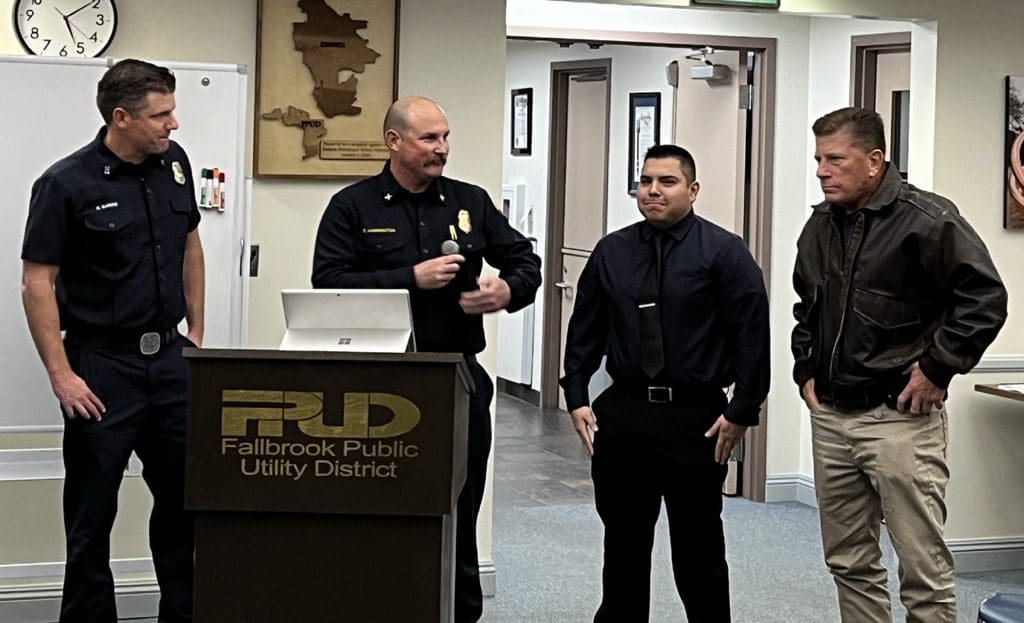 Two uniformed officers standing inside a public utility office.